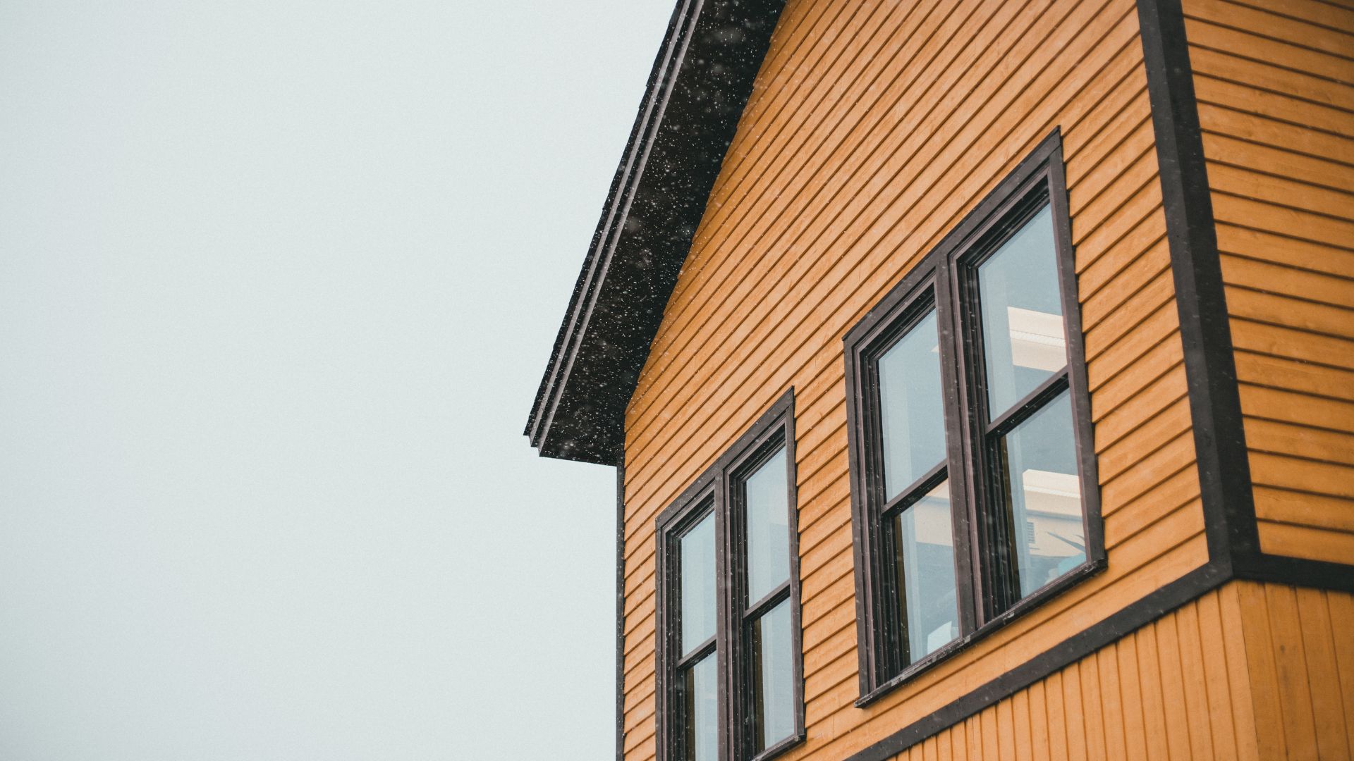 A close up of a yellow building with windows